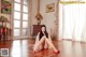 A woman sitting on the floor in a room.