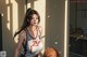 A woman holding a basketball in a room.